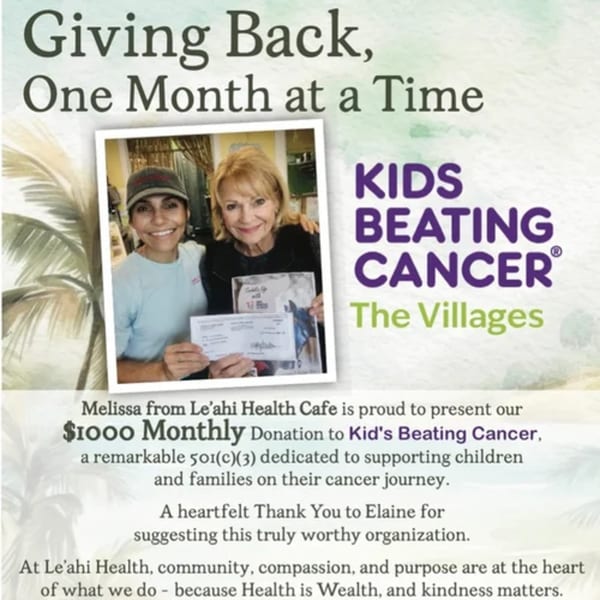Two women smiling, holding a check for $1000 for Kids Beating Cancer, with text overlay.
